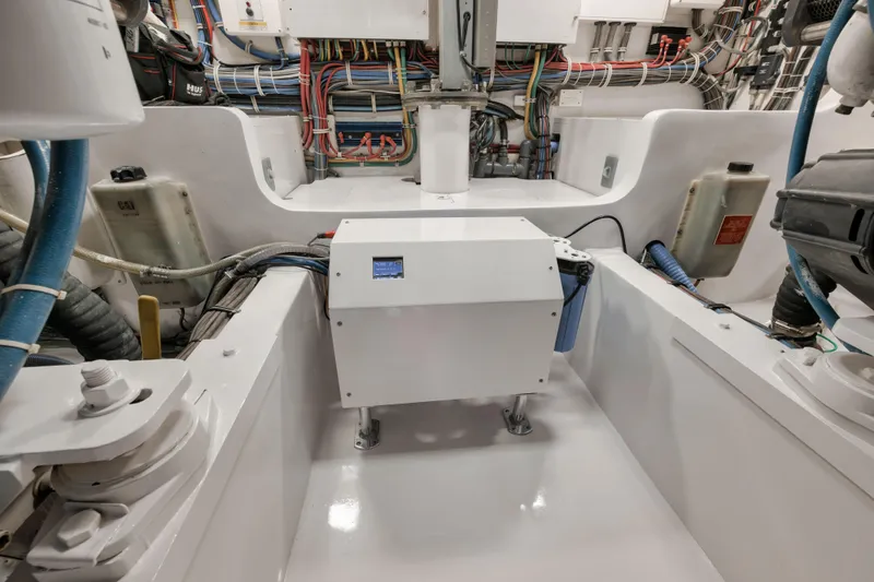 Slide: The Image of Engine room of 2009 Hatteras 60GT yacht, showcasing wiring and equipment. - 44