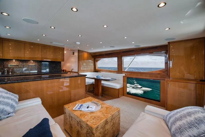 Slide: The Image of Luxurious interior of 2009 Hatteras 60GT yacht with elegant wood finishes and ocean view. - 9