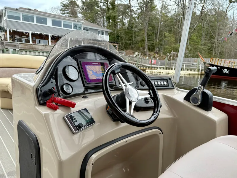 Slide: The Image of 2019 Bentley Pontoons 223 Elite dashboard with steering wheel and navigation system. - 14