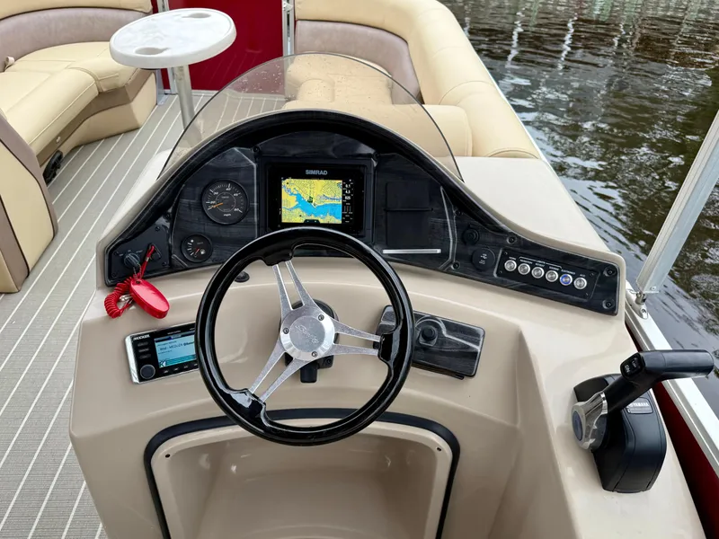 Slide: The Image of 2019 Bentley Pontoons 223 Elite dashboard with steering wheel and navigation system. - 15