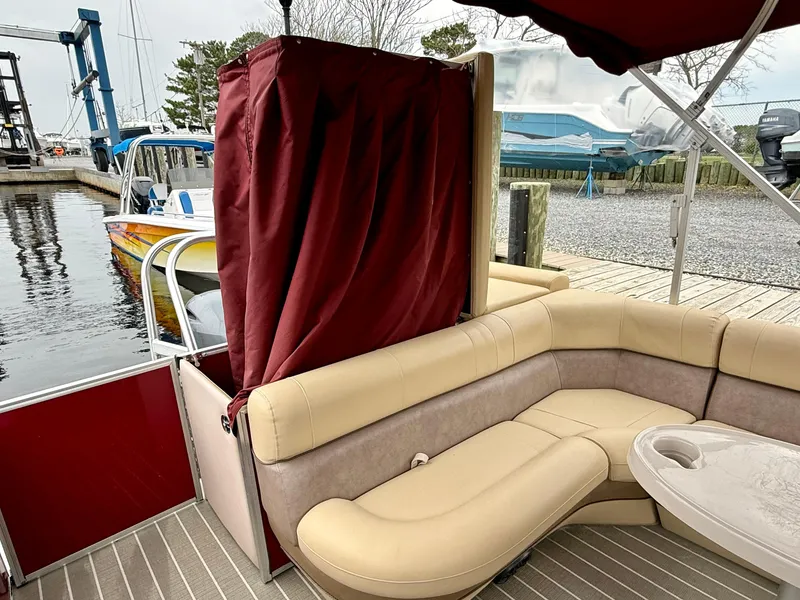 Slide: The Image of 2019 Bentley Pontoons 223 Elite with beige seating and red canopy at a dock. - 20