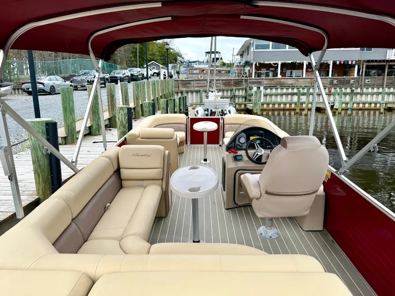Slide: The Image of 2019 Bentley Pontoons 223 Elite with beige seating, docked by a wooden pier. - 21