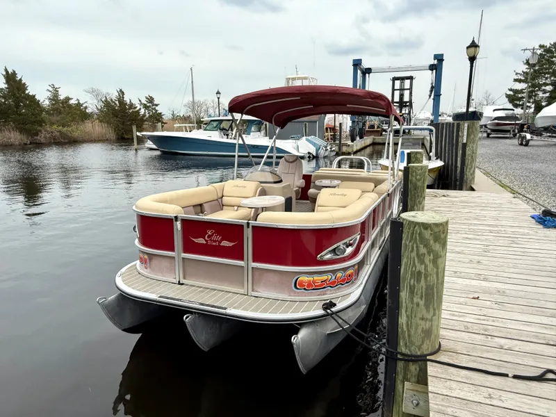 Slide: The Image of 2019 Bentley Pontoons 223 Elite docked, featuring red exterior and spacious seating. - 3