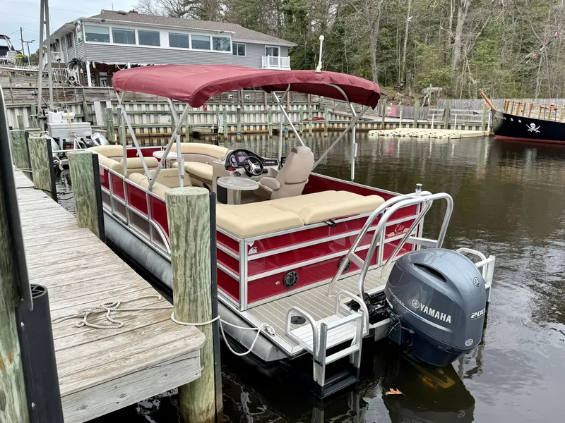 Slide: The Image of 2019 Bentley Pontoons 223 Elite docked with Yamaha outboard motor, red canopy, and beige seating. - 6
