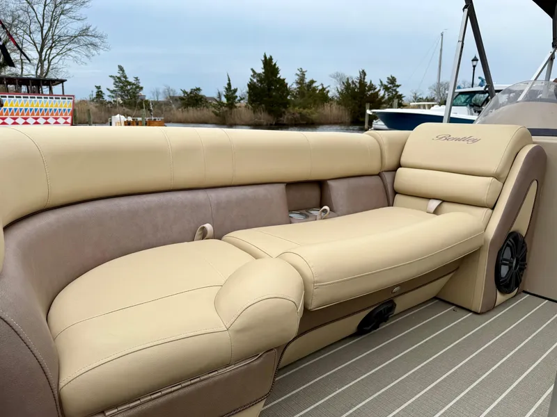 Slide: The Image of 2019 Bentley Pontoons 223 Elite with luxurious beige seating on a pontoon boat. - 9