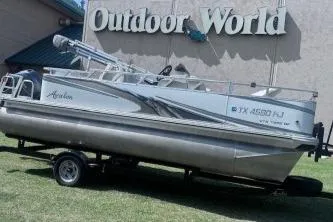 Slide: The Image of 2021 Avalon VTX Quad Fish boat displayed at Outdoor World on a trailer. - 3