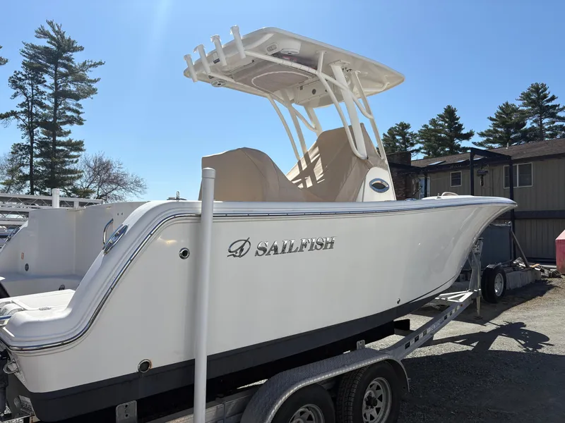Slide: The Image of 2017 Sailfish 236 CC boat on trailer, white hull, outdoor setting. - 0