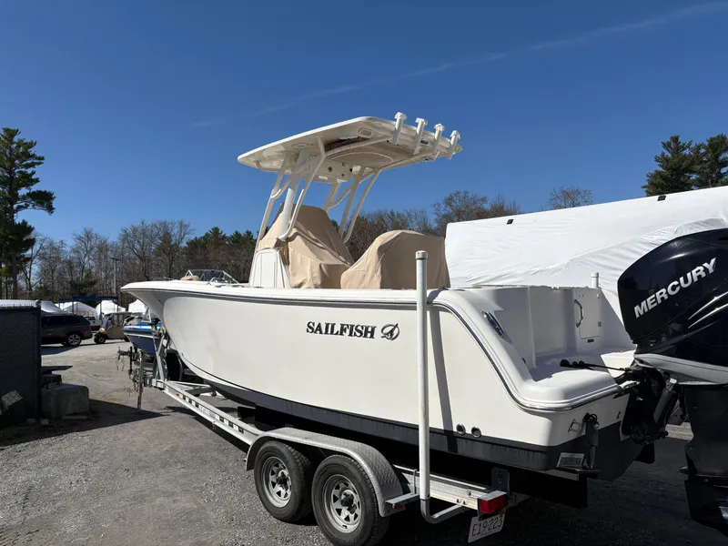 Slide: The Image of 2017 Sailfish 236 CC boat on trailer with Mercury engine, parked outdoors. - 1