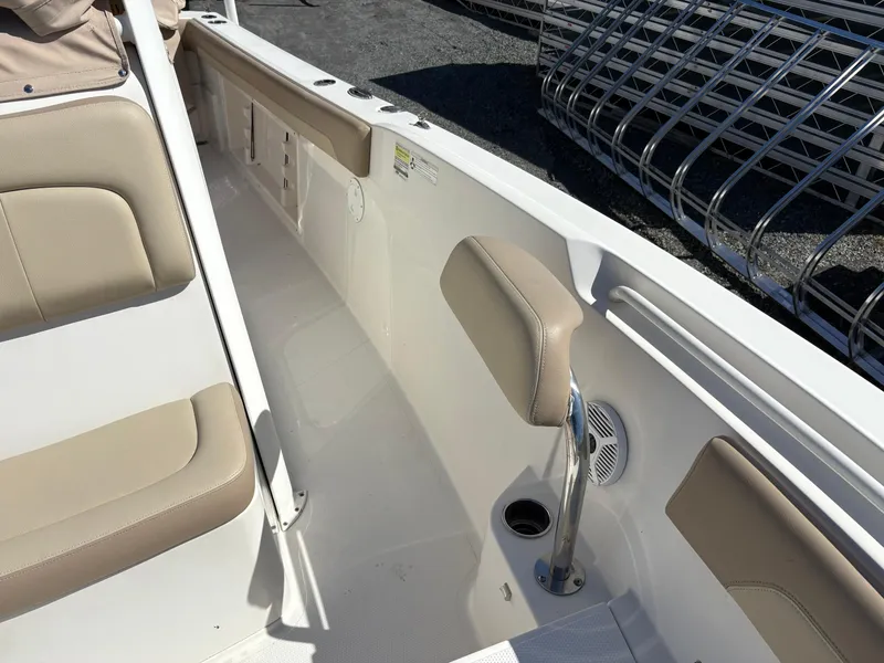 Slide: The Image of 2017 Sailfish 236 CC boat interior with beige seating and cup holder. - 14