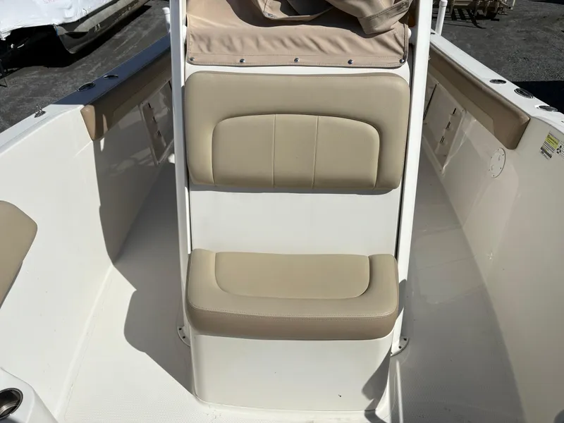 Slide: The Image of 2017 Sailfish 236 CC boat interior with beige seating and white deck. - 16