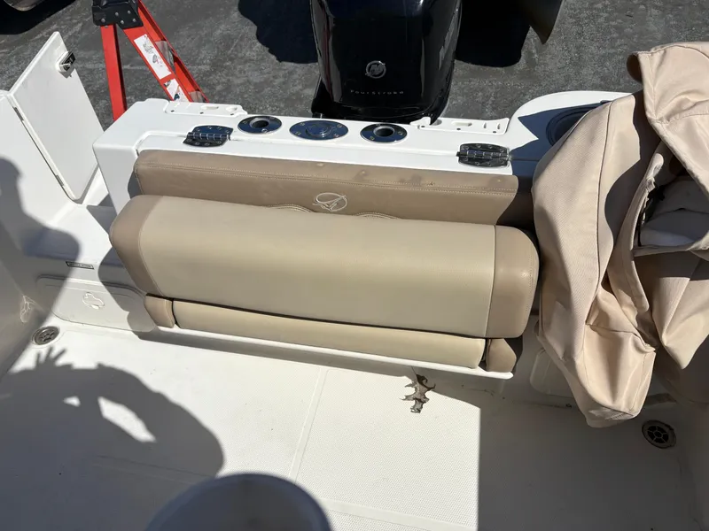 Slide: The Image of 2017 Sailfish 236 CC boat seat with beige upholstery and storage compartment. - 19