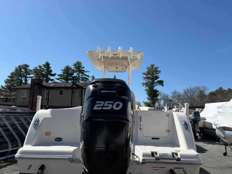 Slide: The Image of 2017 Sailfish 236 CC boat with a 250 Verado engine, parked outdoors. - 2