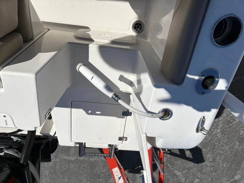 Slide: The Image of 2017 Sailfish 236 CC boat deck with hose attachment and seating area. - 21