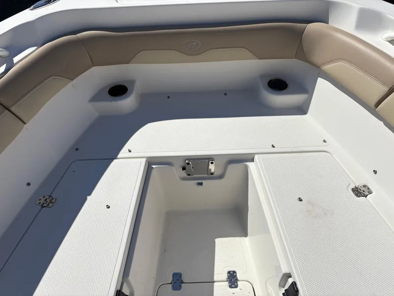 Slide: The Image of 2017 Sailfish 236 CC boat interior with cushioned seating and storage compartments. - 24
