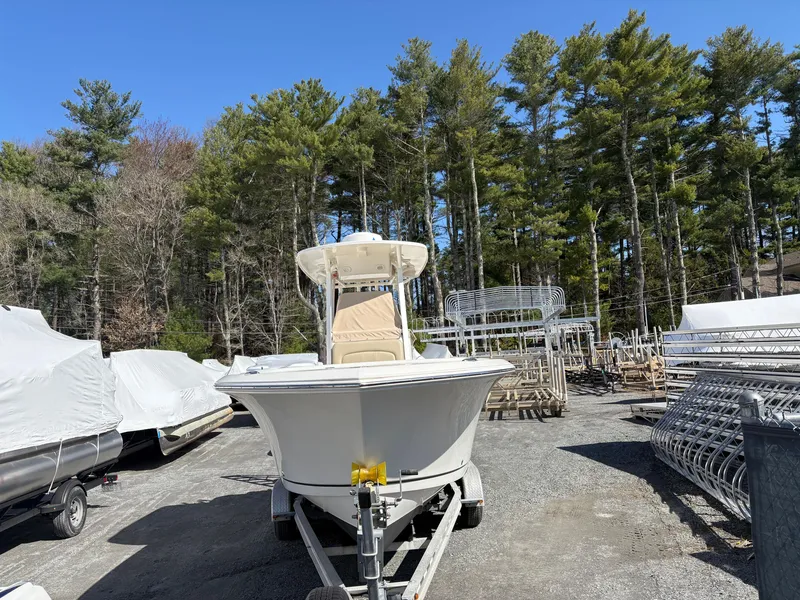 Slide: The Image of 2017 Sailfish 236 CC boat on trailer, surrounded by trees and equipment. - 3