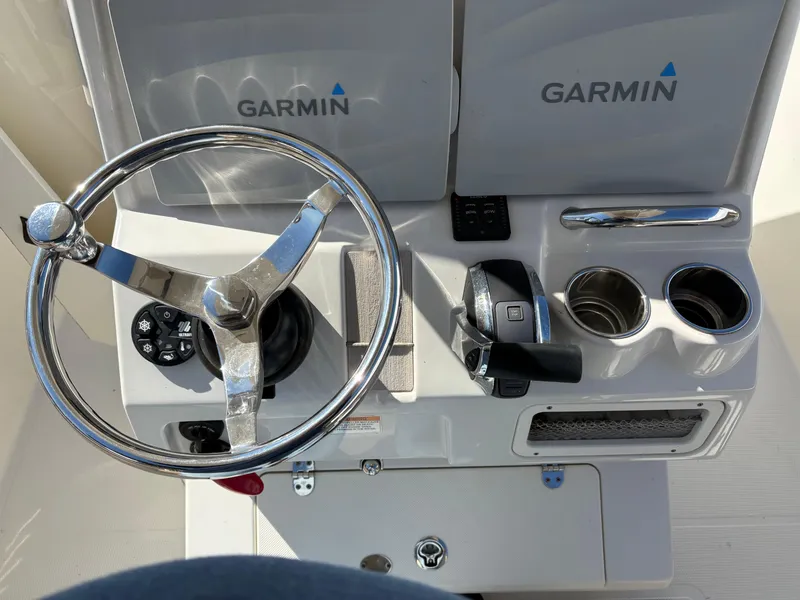 Slide: The Image of 2017 Sailfish 236 CC boat helm with Garmin electronics and steering wheel. - 6