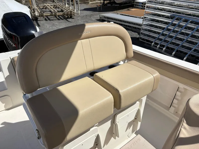 Slide: The Image of 2017 Sailfish 236 CC boat with beige cushioned seating and visible outboard motor. - 8
