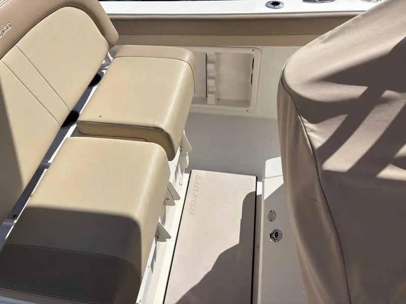 Slide: The Image of 2017 Sailfish 236 CC boat interior with beige seating and covered console. - 9
