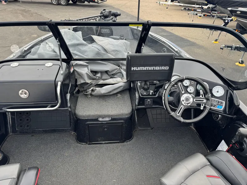 Slide: The Image of Black Nitro ZV21 boat seat, 2019 model, with red accents and carpeted flooring. - 15
