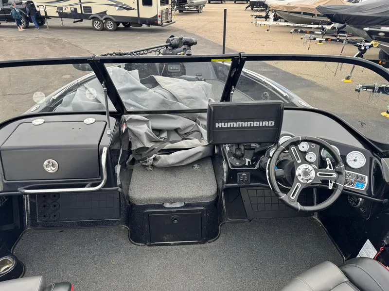 Slide: The Image of Open storage compartment in a 2019 Nitro ZV21 boat, featuring a blue interior. - 16