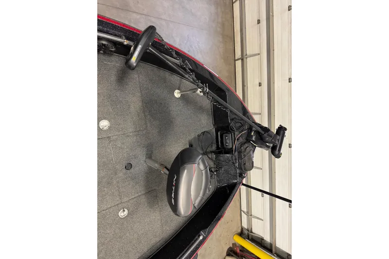 Slide: The Image of 2019 Nitro ZV21 boat interior with steering and seating in a garage setting. - 24