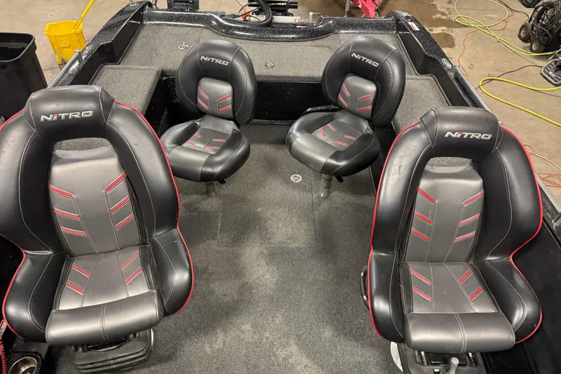 Slide: The Image of 2019 Nitro ZV21 boat interior with four black and red seats. - 28