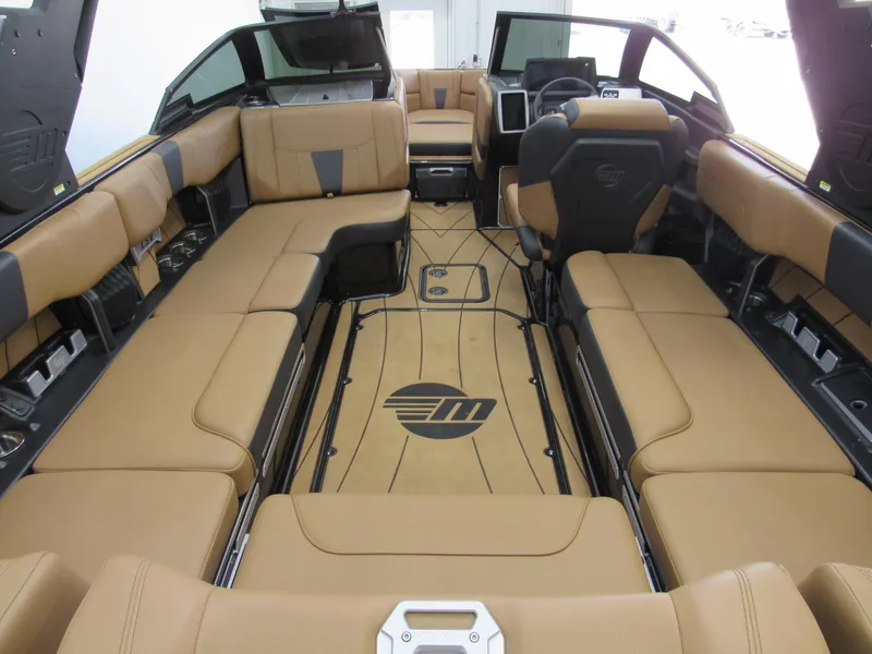 Slide: The Image of 2022 Malibu Wakesetter 23 LSV interior with tan seating and modern dashboard. - 4