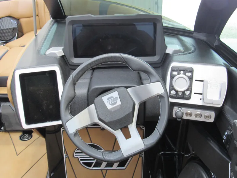 Slide: The Image of 2022 Malibu Wakesetter 23 LSV dashboard with modern steering and digital displays. - 8