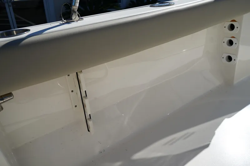 Slide: The Image of 2023 Key West 189 FS boat interior detail with rod holders and clean white finish. - 12