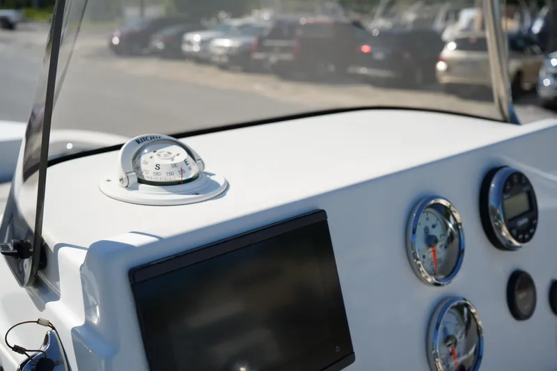 Slide: The Image of 2023 Key West 189 FS boat dashboard with compass and gauges. - 15