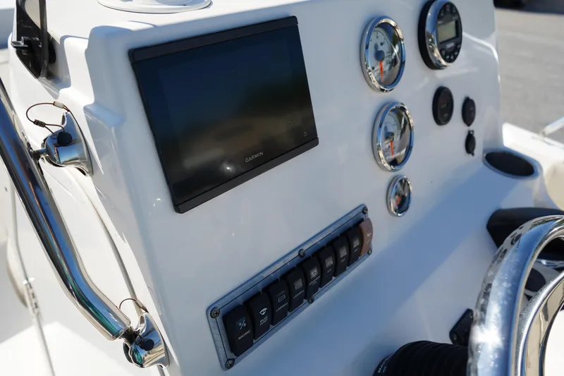Slide: The Image of 2023 Key West 189 FS boat dashboard with gauges, switches, and a display screen. - 16