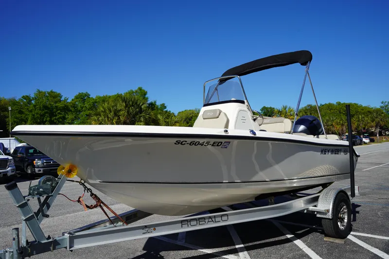 Slide: The Image of 2023 Key West 189 FS boat on trailer in parking lot, clear blue sky. - 2