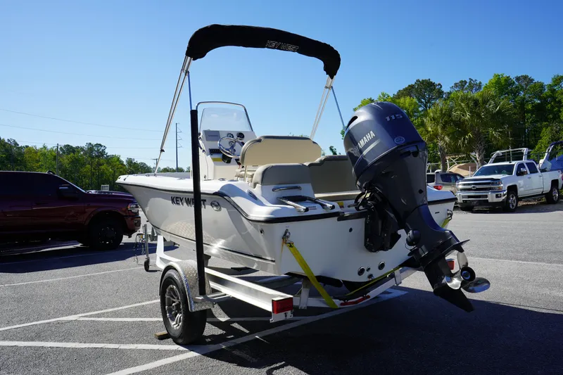 Slide: The Image of 2023 Key West 189 FS boat with Yamaha engine on trailer in parking lot. - 4