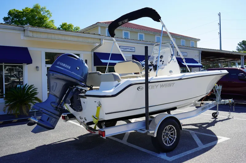 Slide: The Image of 2023 Key West 189 FS boat on trailer, parked outside a building. - 5