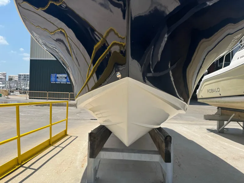 Slide: The Image of 2015 Sea Hunt Ultra 234 boat hull on display at a marina. - 10