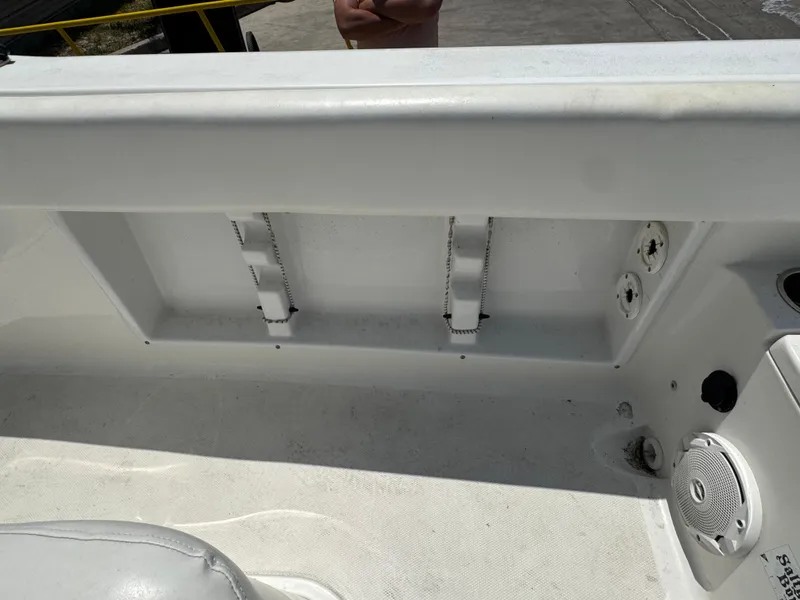 Slide: The Image of Interior view of a 2015 Sea Hunt Ultra 234 boat, featuring storage compartments and speaker. - 15