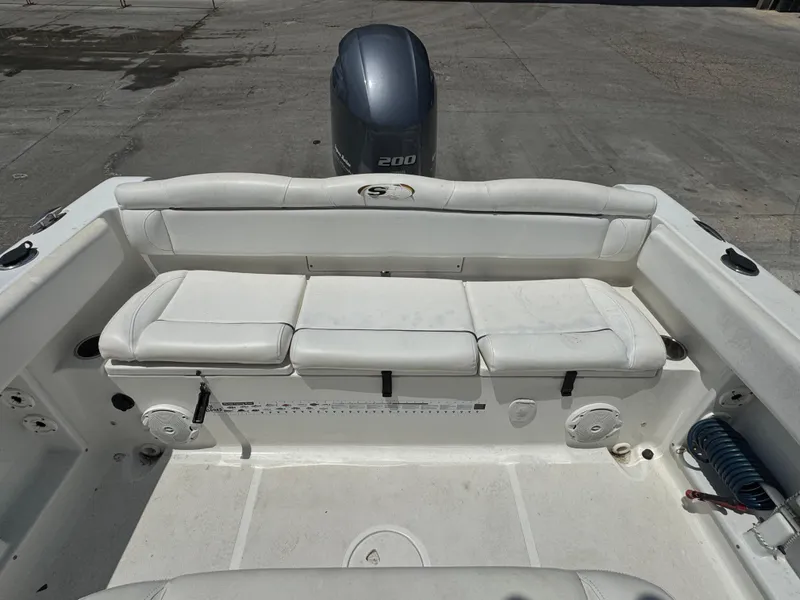 Slide: The Image of 2015 Sea Hunt Ultra 234 boat with white seating and outboard motor. - 18