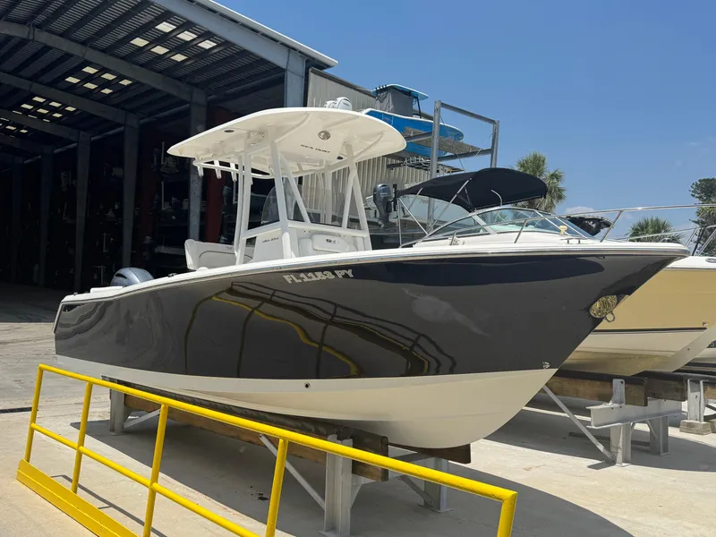 Slide: The Image of 2015 Sea Hunt Ultra 234 boat in storage, featuring sleek design and modern amenities. - 2