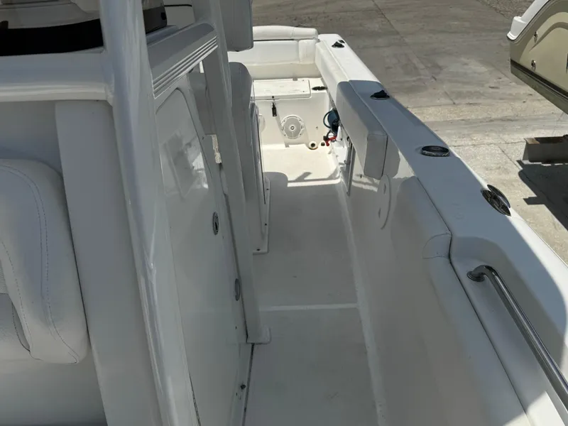 Slide: The Image of 2015 Sea Hunt Ultra 234 boat interior, featuring sleek white seating and storage compartments. - 21