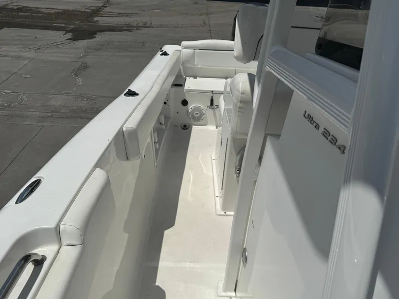 Slide: The Image of 2015 Sea Hunt Ultra 234 boat interior, featuring white seating and sleek design. - 23