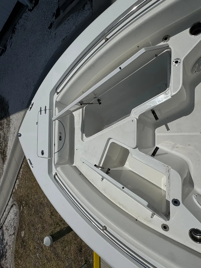 Slide: The Image of 2015 Sea Hunt Ultra 234 boat interior with open storage compartments. - 27