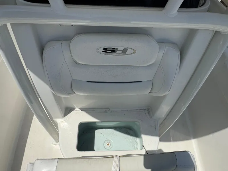 Slide: The Image of 2015 Sea Hunt Ultra 234 boat interior with seating and storage compartment. - 28