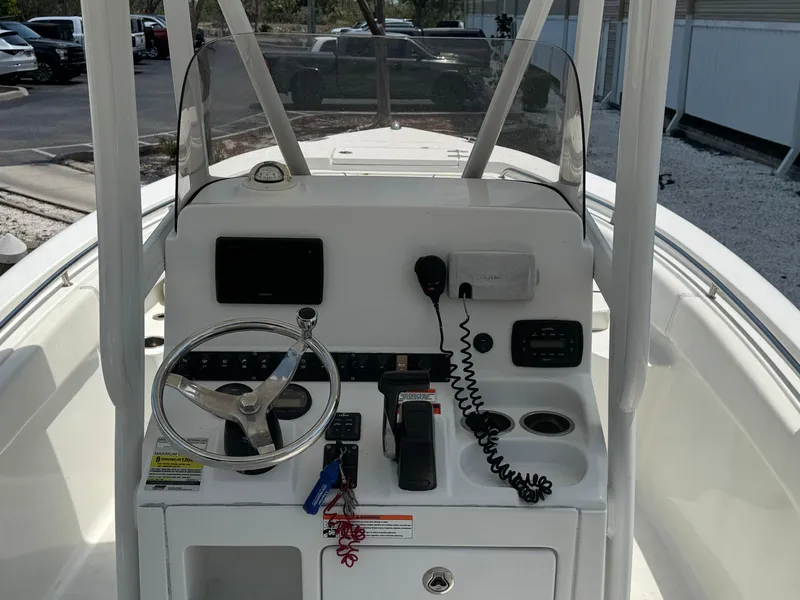 Slide: The Image of 2015 Sea Hunt Ultra 234 boat console with steering wheel, controls, and navigation equipment. - 31