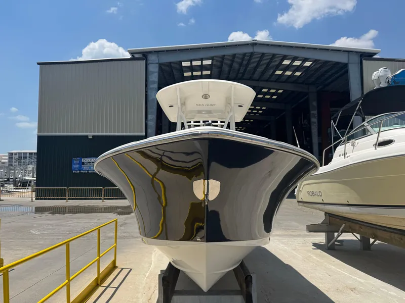 Slide: The Image of 2015 Sea Hunt Ultra 234 boat in marina, front view, sunny day. - 5