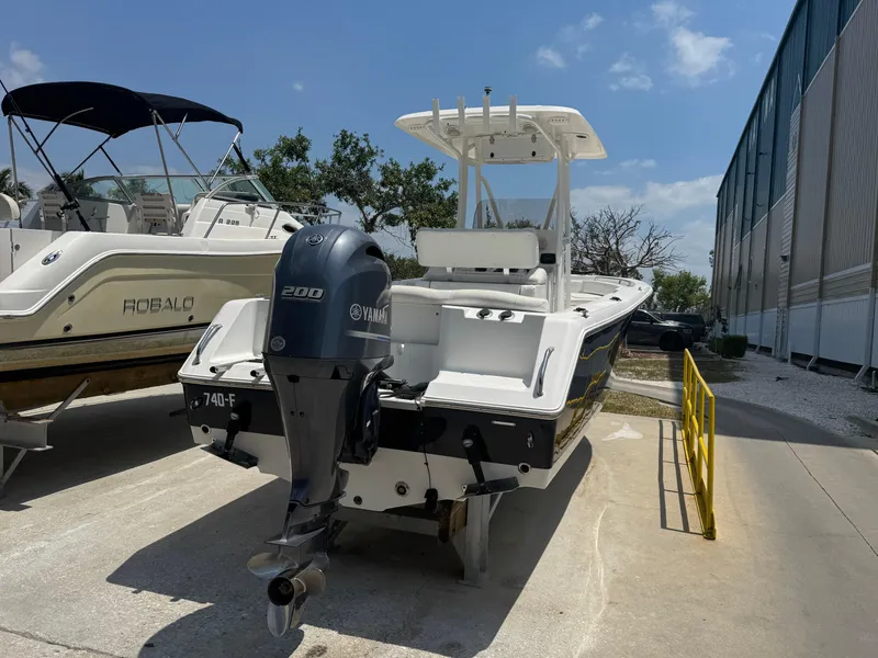 Slide: The Image of 2015 Sea Hunt Ultra 234 boat with Yamaha 200 engine, parked outdoors. - 6