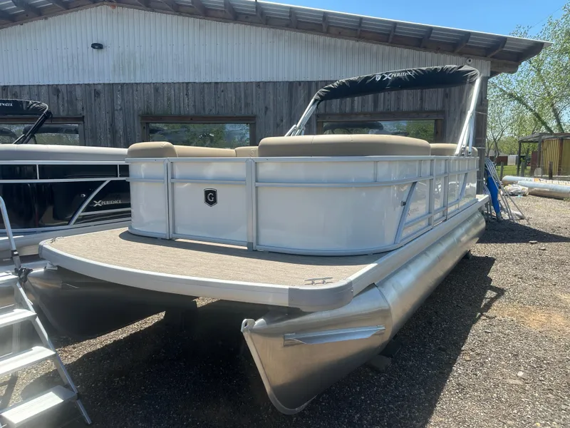 Slide: The Image of 2025 Godfrey Xperience 2086 CXP pontoon boat with canopy, parked outdoors. - 0