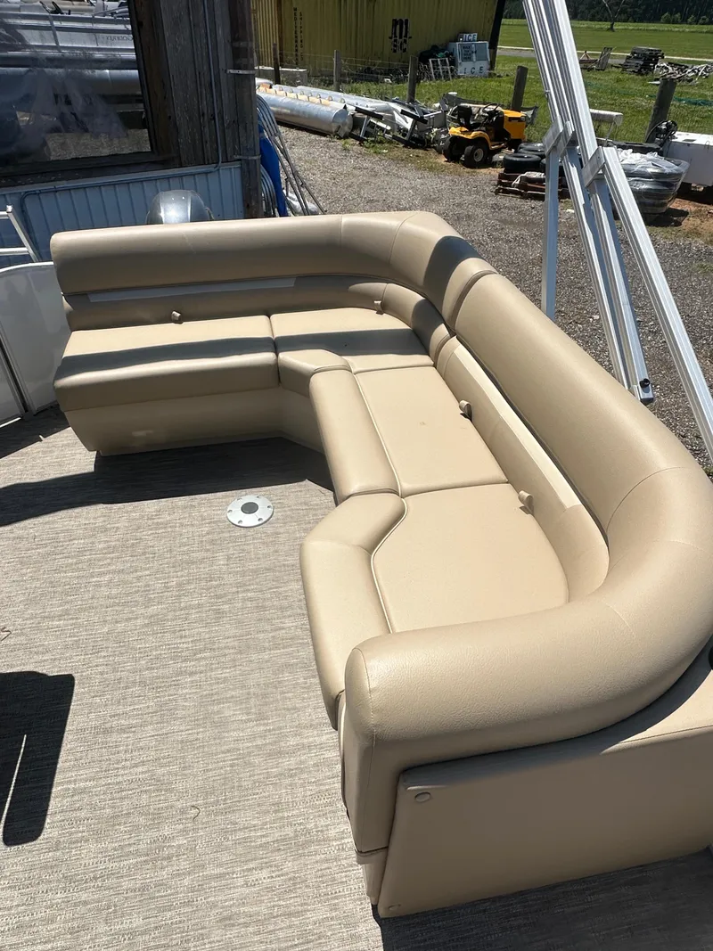 Slide: The Image of 2025 Godfrey Xperience 2086 CXP boat with beige seating on deck. - 11
