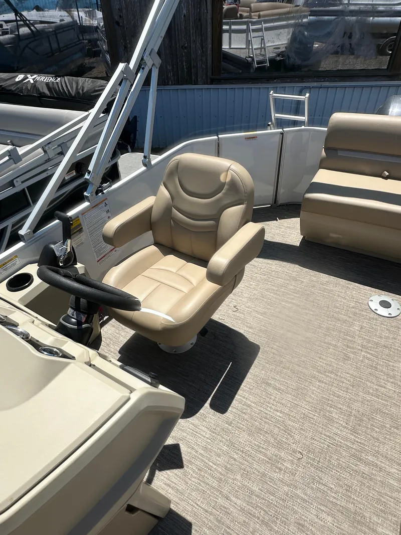 Slide: The Image of 2025 Godfrey Xperience 2086 CXP boat interior with beige captain's chair and seating. - 12