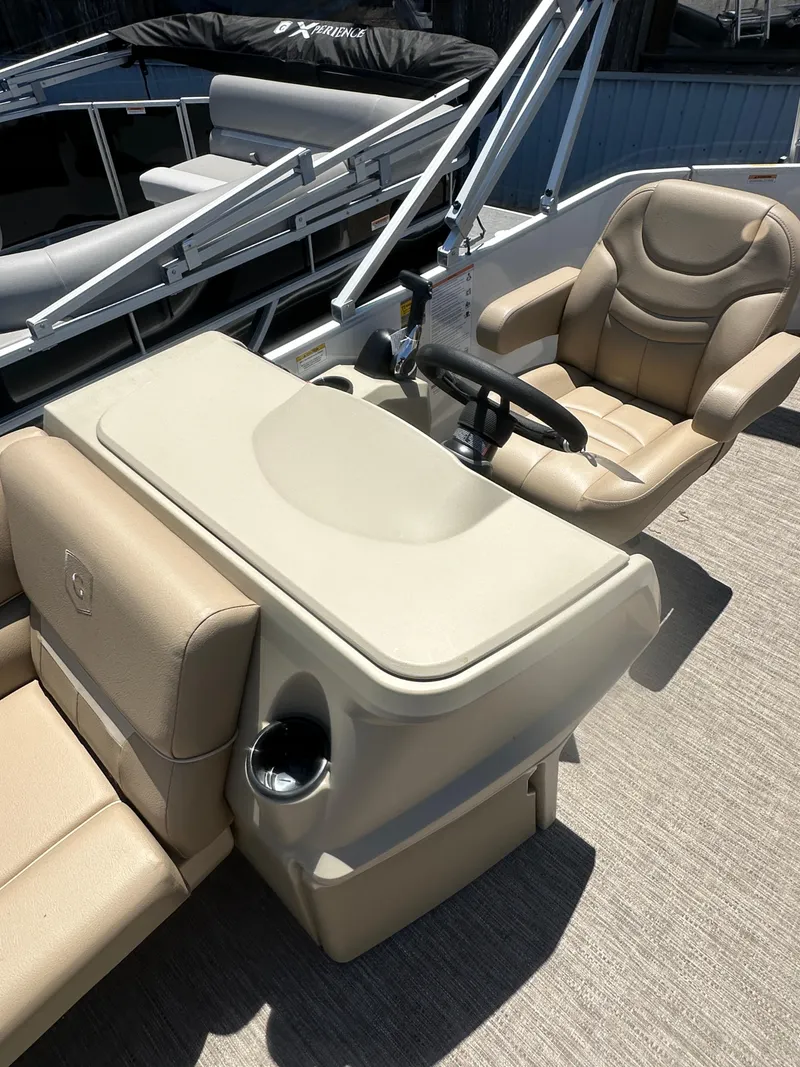 Slide: The Image of 2025 Godfrey Xperience 2086 CXP boat interior with beige seating and steering console. - 13