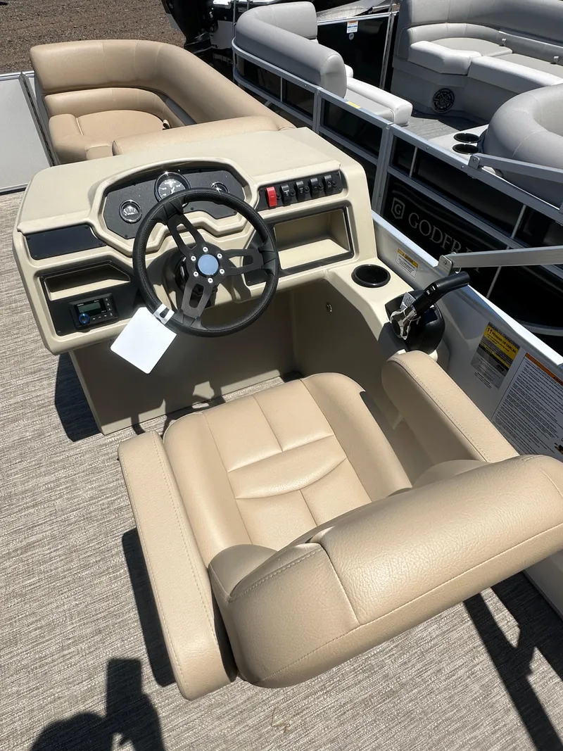 Slide: The Image of 2025 Godfrey Xperience 2086 CXP boat interior with beige seating and steering console. - 15
